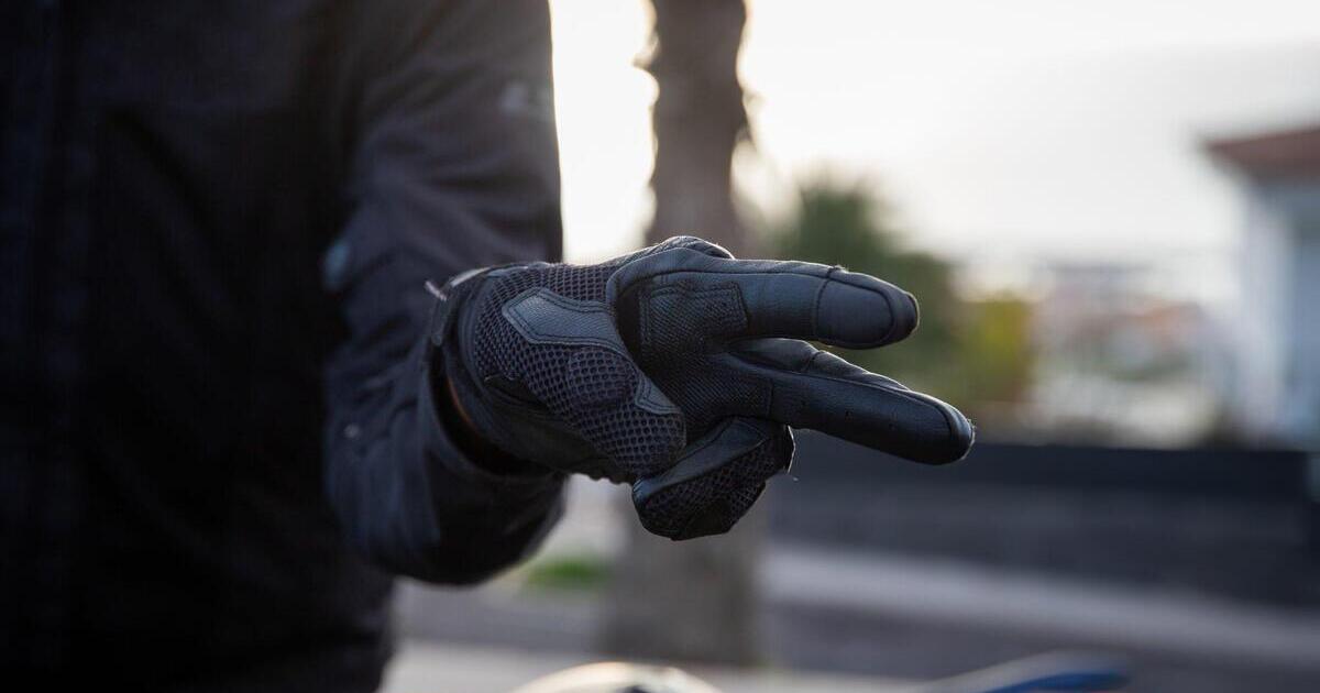 A dirt bike rider wearing protection gloves