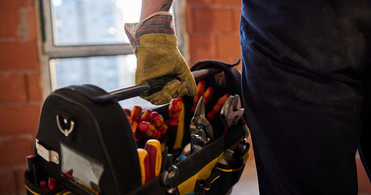 A person holding a motocross tool kits