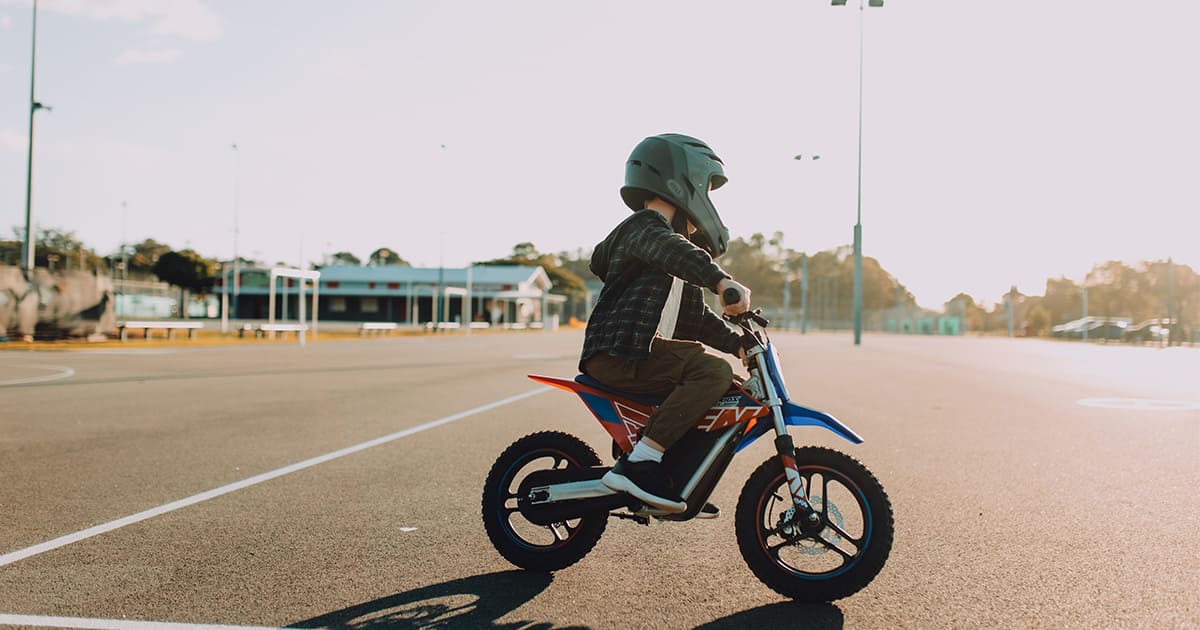 a boy is riding his dirt bike in the park